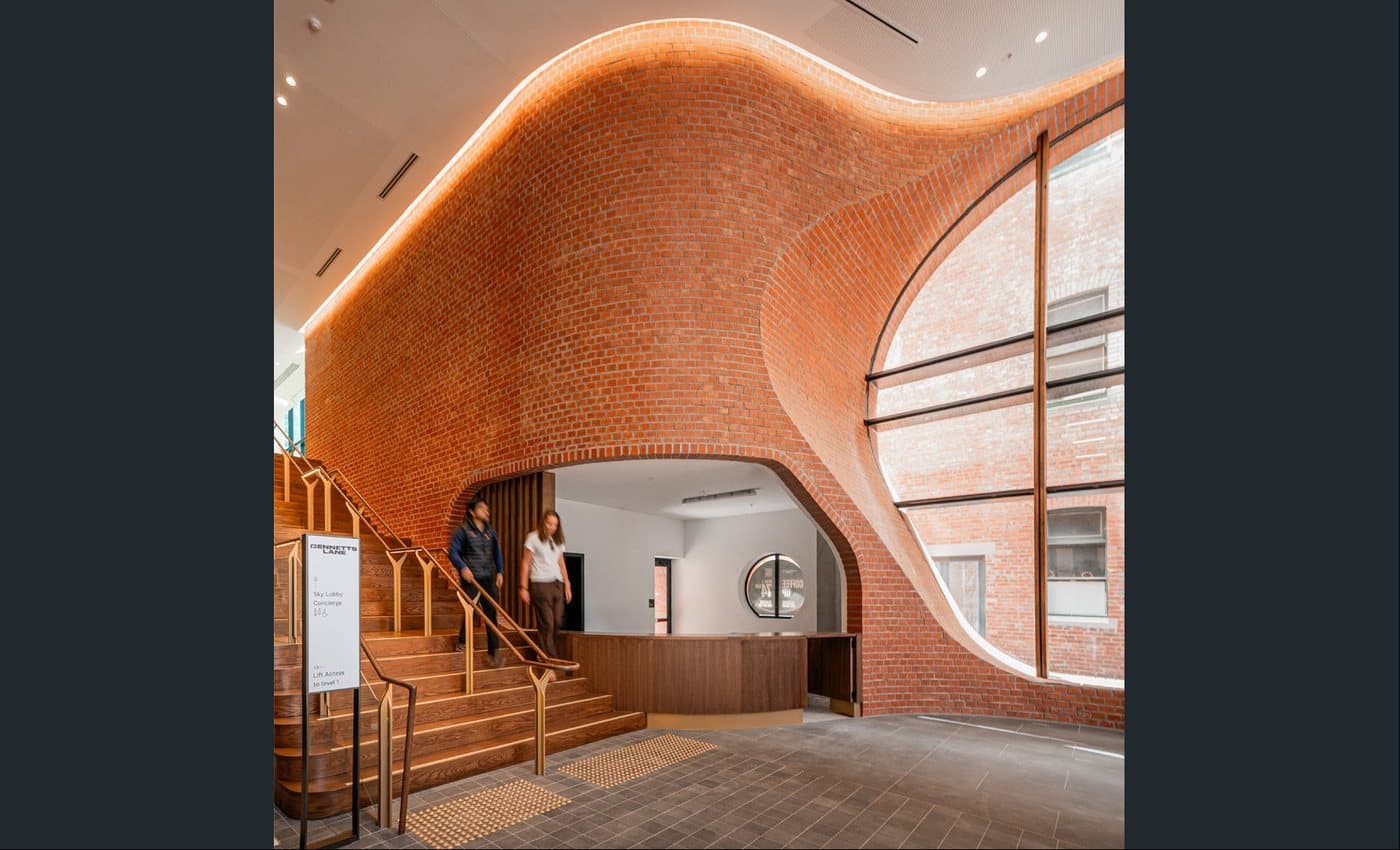 Curved orange brick interior built with a mechanically fixed brick system